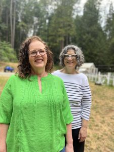 Red-headed author/speaker Kathi Lipp wears a lime green bohemian tunic and edgy leopard-print glasses. Tonya, slightly out of focus, is a few paces behind her in signature black-and-white (striped shirt and bold glasses)