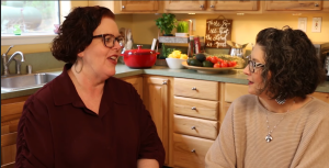 Red-headed Kathi Lipp (wearing a burgundy bohemian tunic) and Tonya Kubo (wearing beige, in a departure from her typical black and white), sit at Kathi's dining room table.